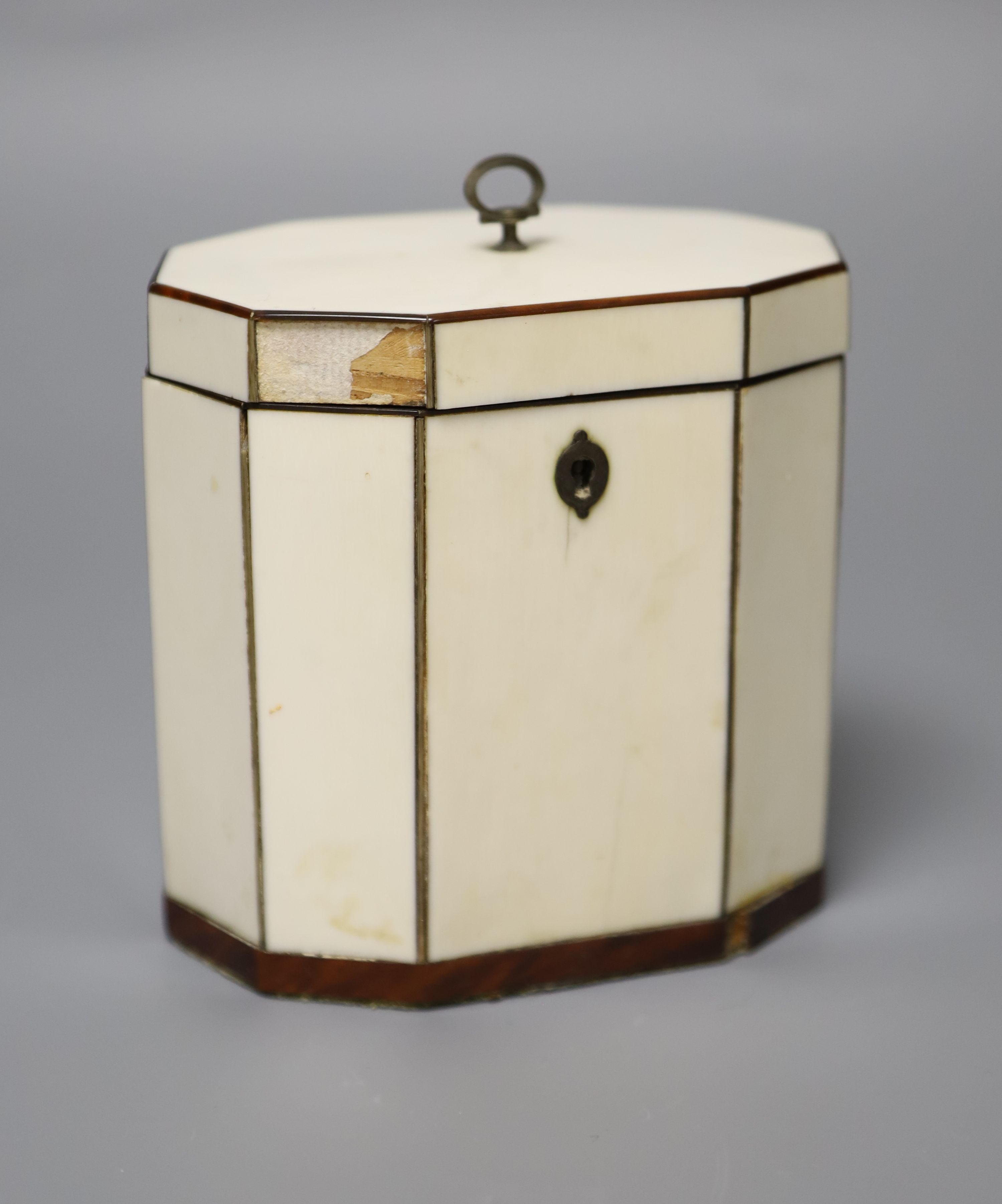 A George III octagonal ivory and tortoiseshell veneered tea caddy, height 10cm